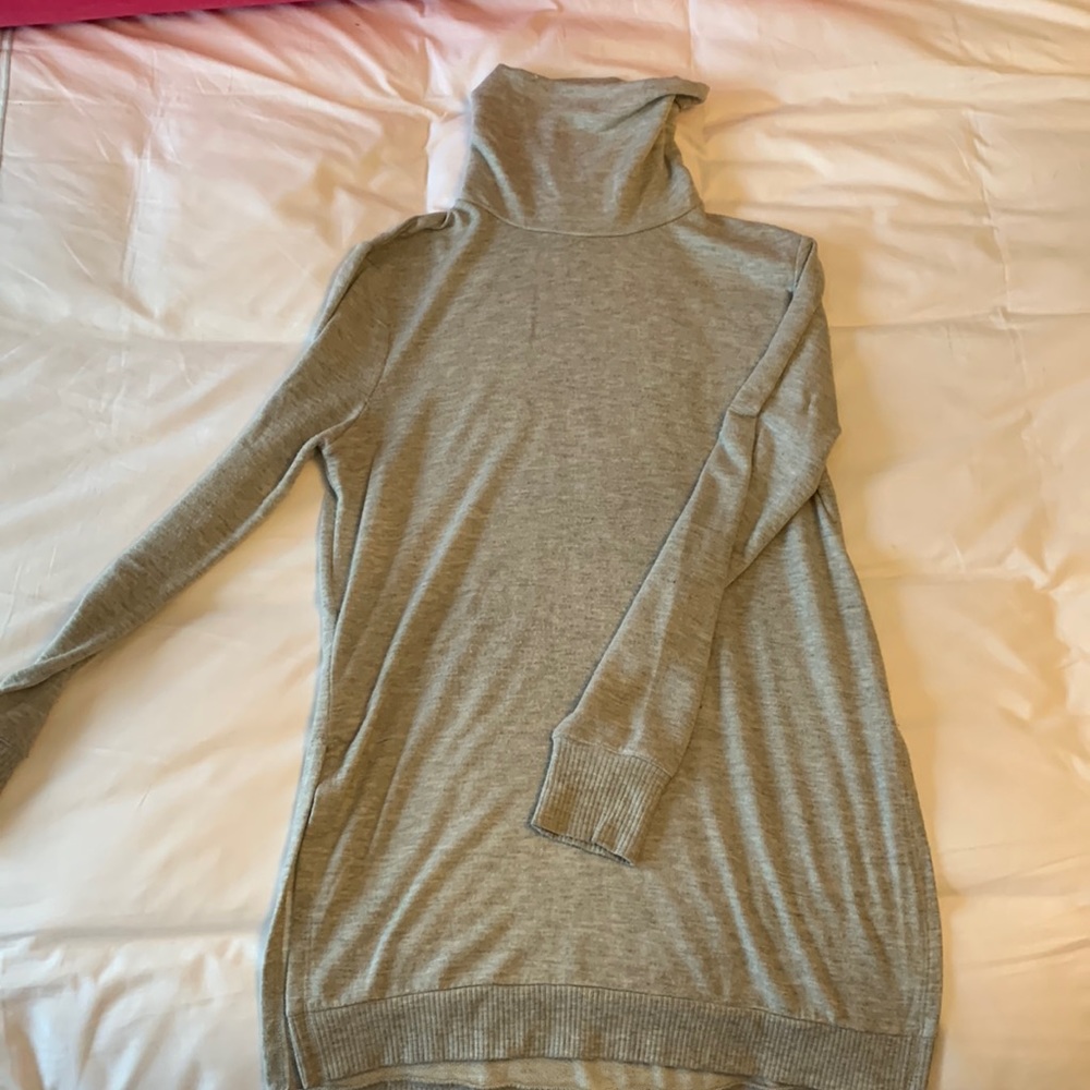 Long sleeved, long turtle neck. Had slits on side of hip.